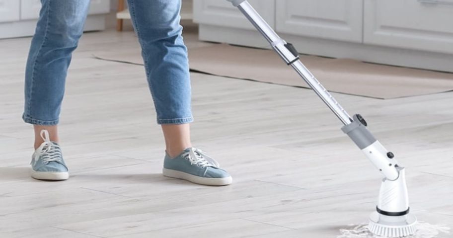 person using electric scrubber on floor