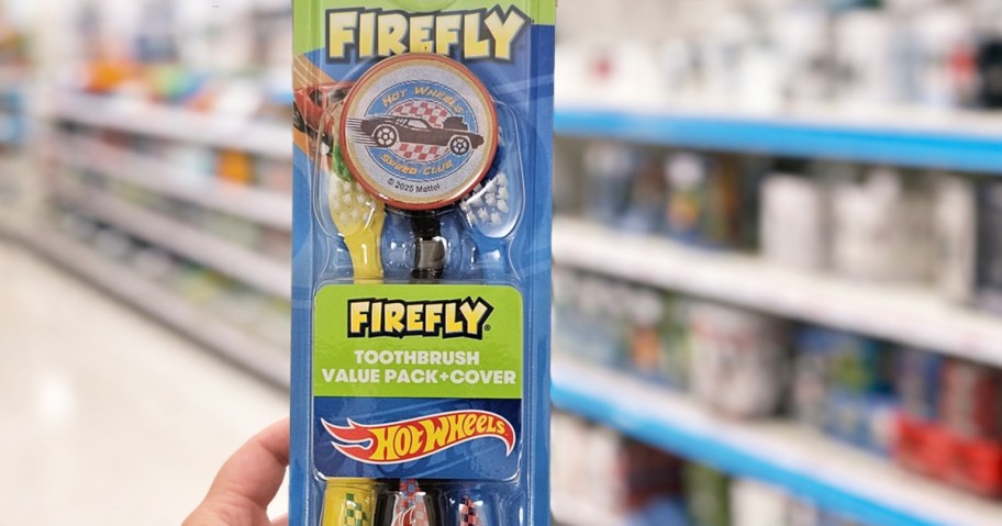 hand holding a pack of Firefly Hot Wheels Toothbrushes in store