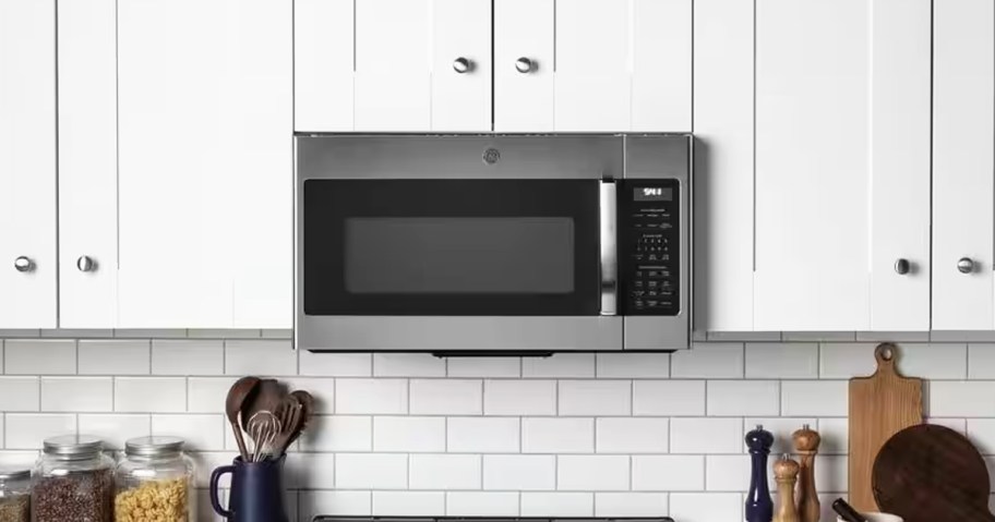 stainless steel and black microwave over oven in kitchen 
