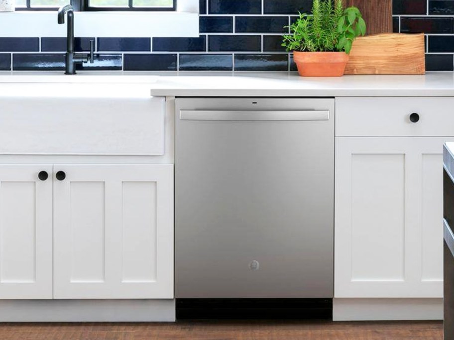 stainless steel dishwasher in kitchen with white cabinets