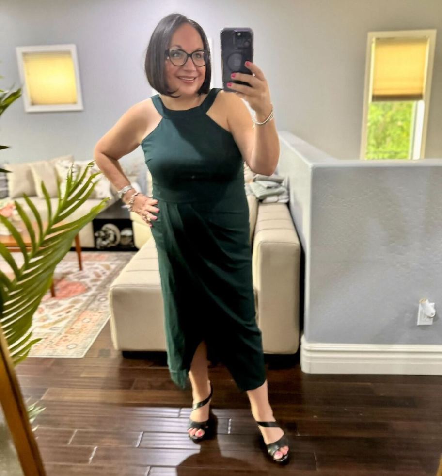 woman taking selfie in mirror wearing green dress