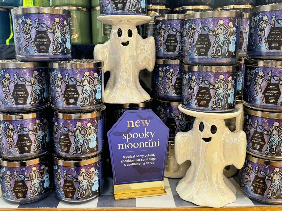 ghost candle holders surrounded by 3-wick candles