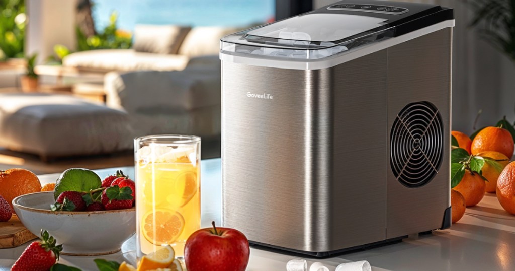 silver countertop ice maker on table next to cold drinks