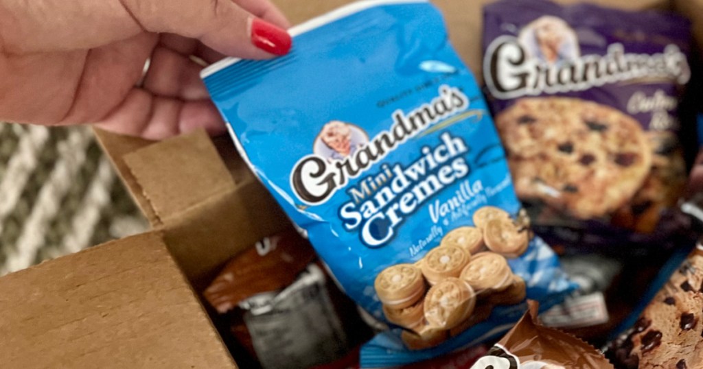 woman grabbing mini cookies from Amazon box