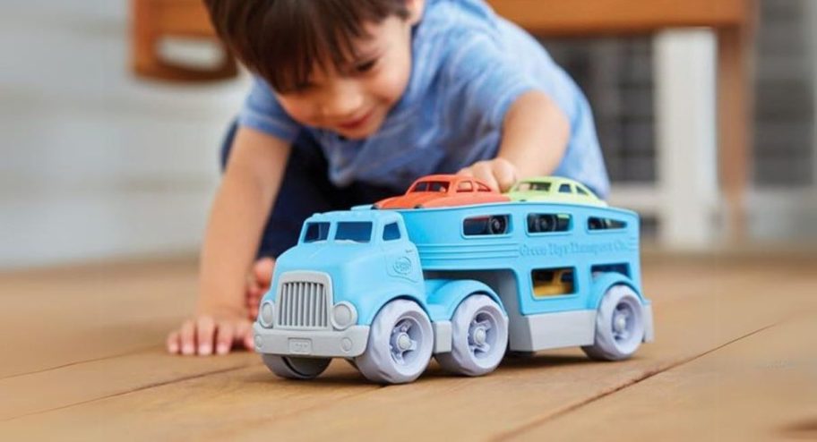 boy playing with Green Toys Car Carrier Vehicle