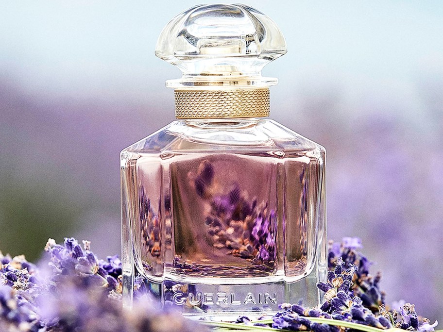 bottle of Guerlain perfume on top of lavender sprigs