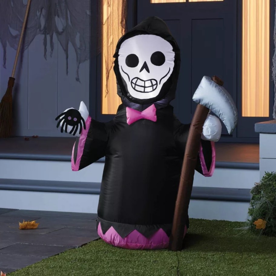 inflatable Grim Reaper with a purple bow tie