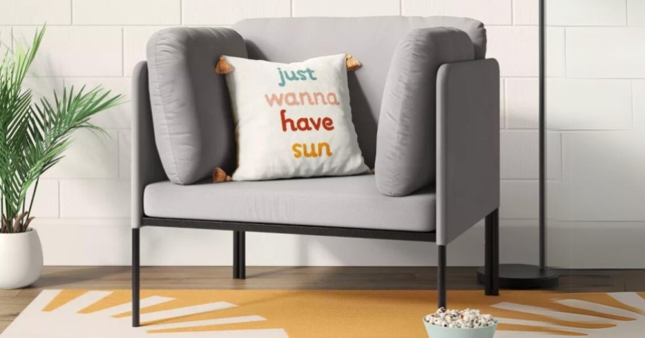 grey and black metal accent chair with throw pillow that says "Just Wanna Have sun" on a yellow sunbeam rug