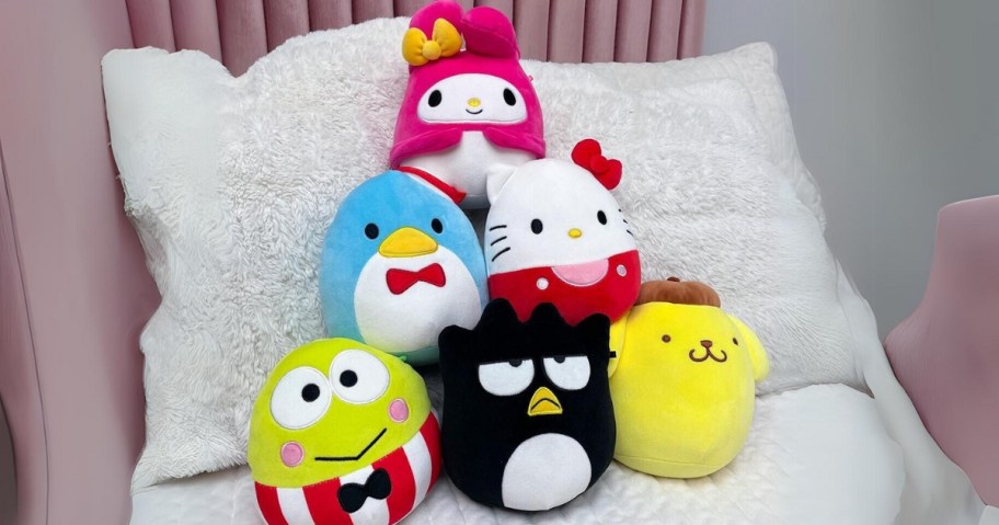 Hello Kitty & Friends Squishmallows collection with 6 different characters stacked on a bed