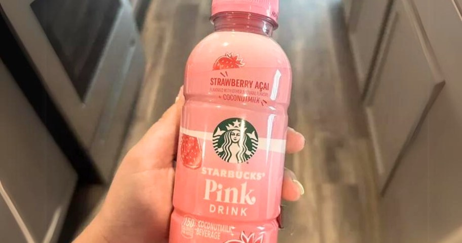 hand holding a Starbucks Pink Drink bottle