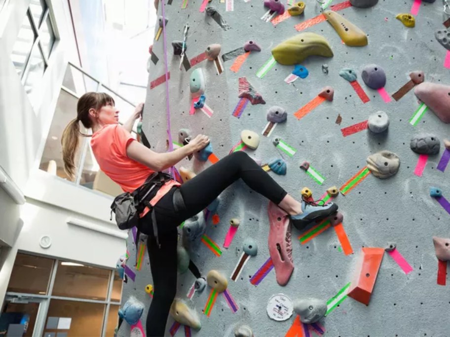 woman climbing on an indoor rock wall 