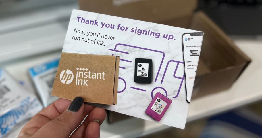 hand holding a HP Instant Ink postcard