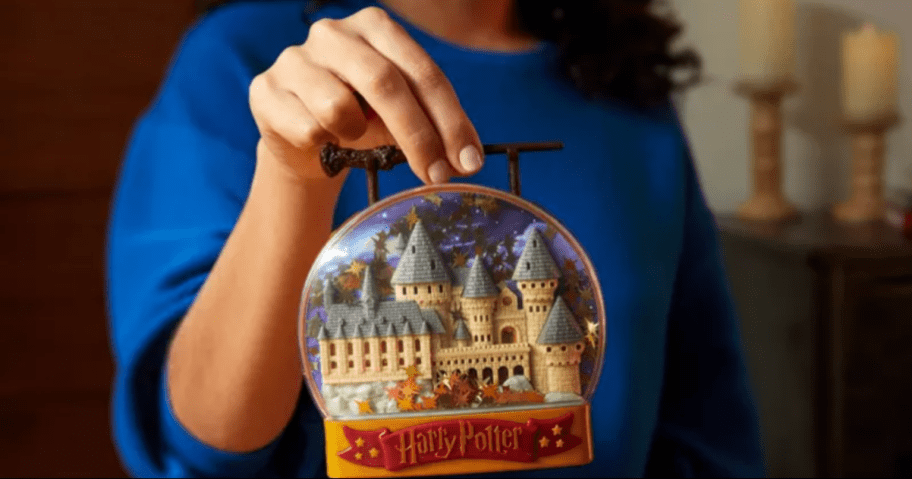 Girl holding up a Harry Potter Themed Polly Pocket Toy Set