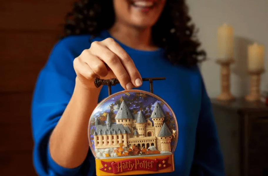 Girl holding up a Harry Potter Themed Polly Pocket Toy Set