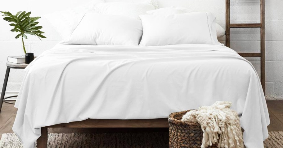 white sheets and pillows on a bed