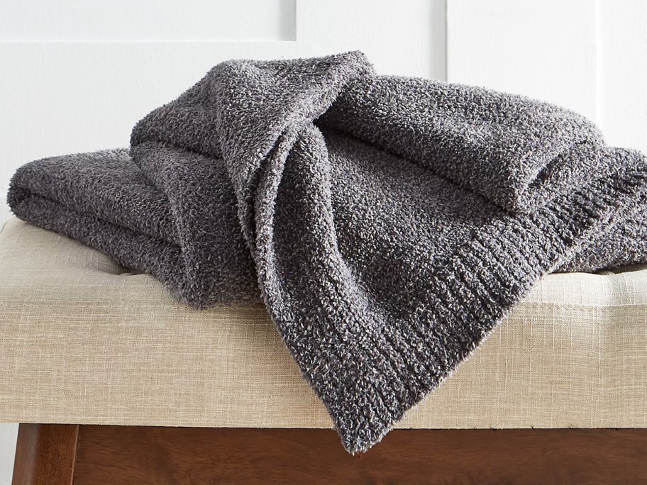 dark grey throw blanket on ottoman