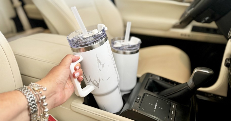 hand grabbing a marble print 40oz tumbler from car cup holder
