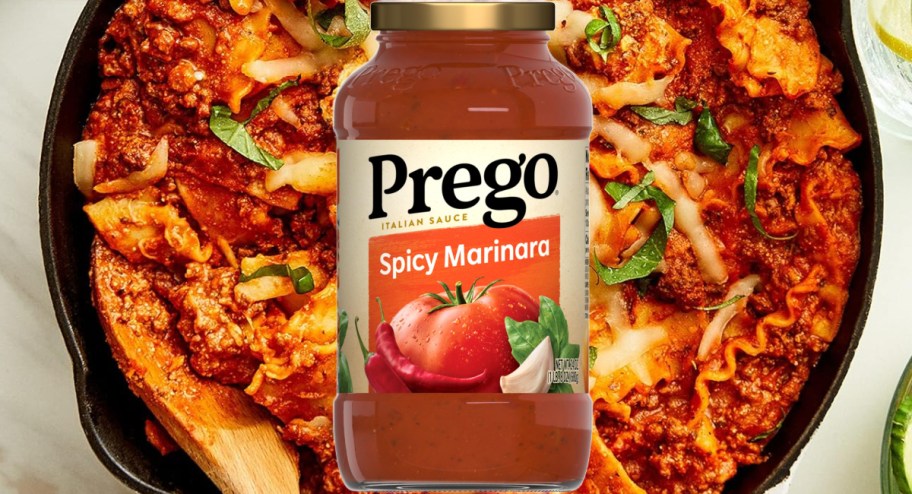 Jar of spicy Preg marinara sauce displayedin front of some pasta noddles