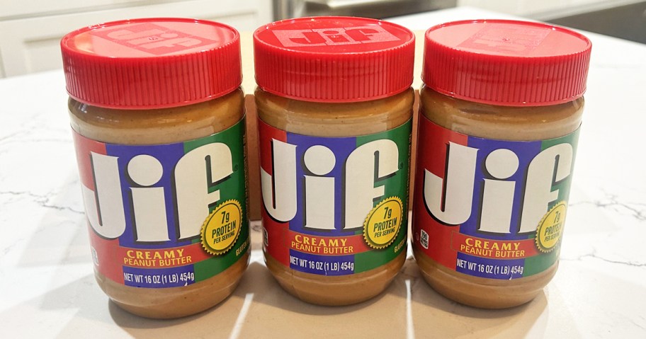 three jif peanut butter jars on kitchen counter