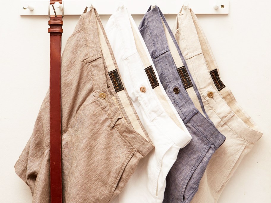 multiple pairs of linen shorts hanging on hooks