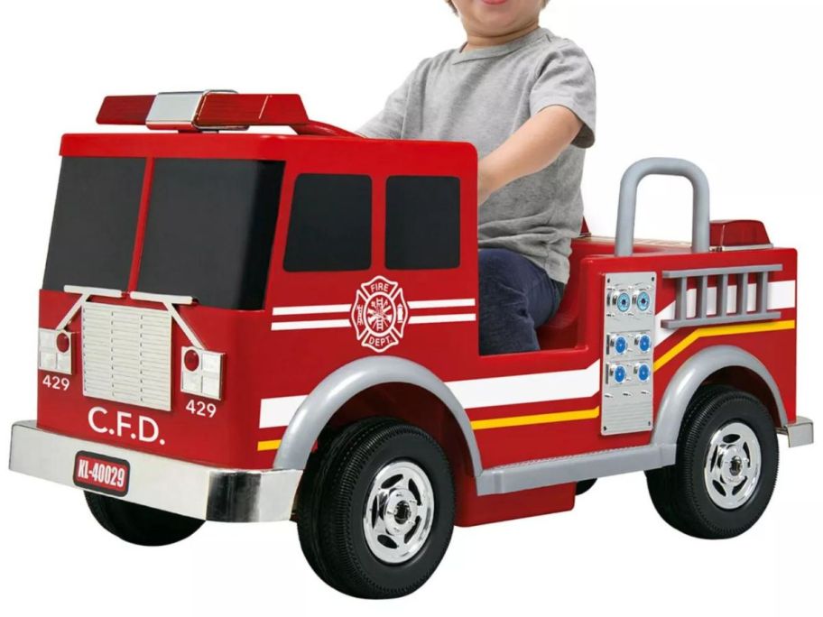 A child on a toy Fire Truck Ride-On