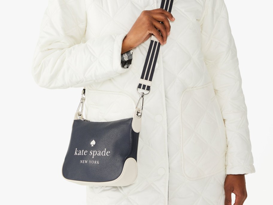 woman in white jacket with black crossbody bag