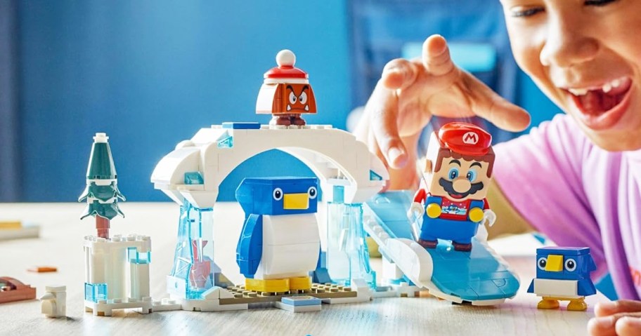 child playing with LEGO Super Mario Penguin Family Snow Adventure Expansion Set