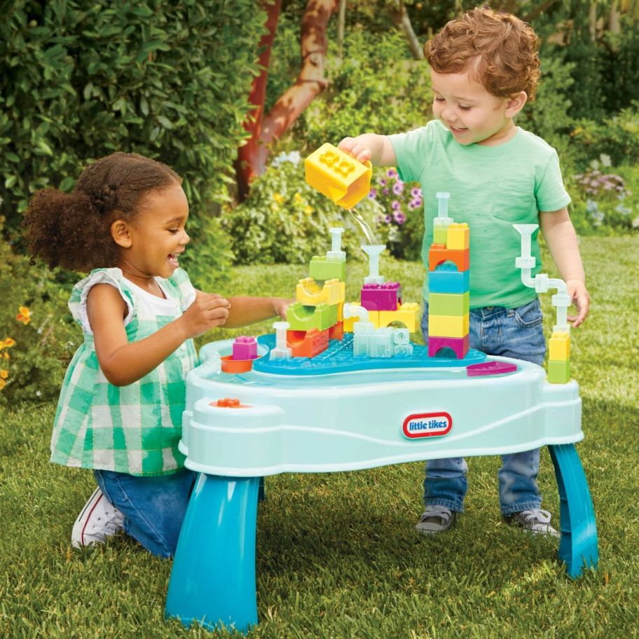 two kids playing on a little tikes water table