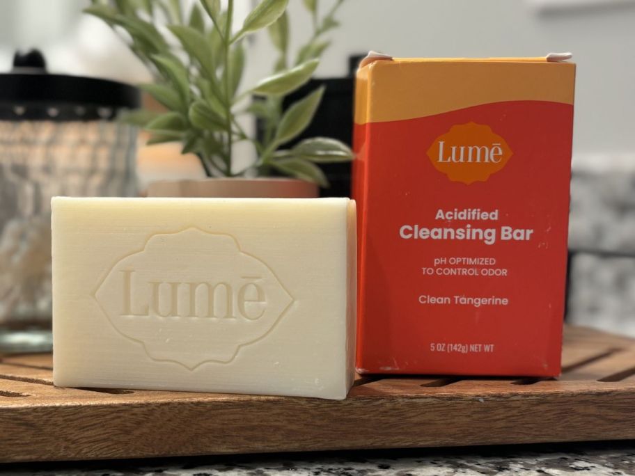 A Lume bar soap next to the box it comes in