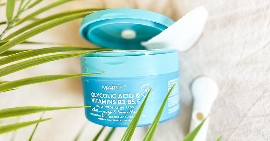 opened blue container of Maree Glycolic Acid Pads near green leaves