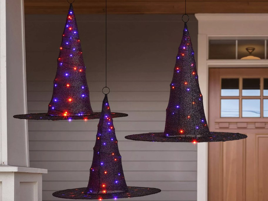 3 lighted witch hats hanging near front door