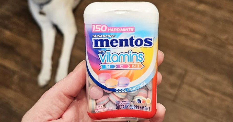 hand holding a bottle of Mentos Vitamins