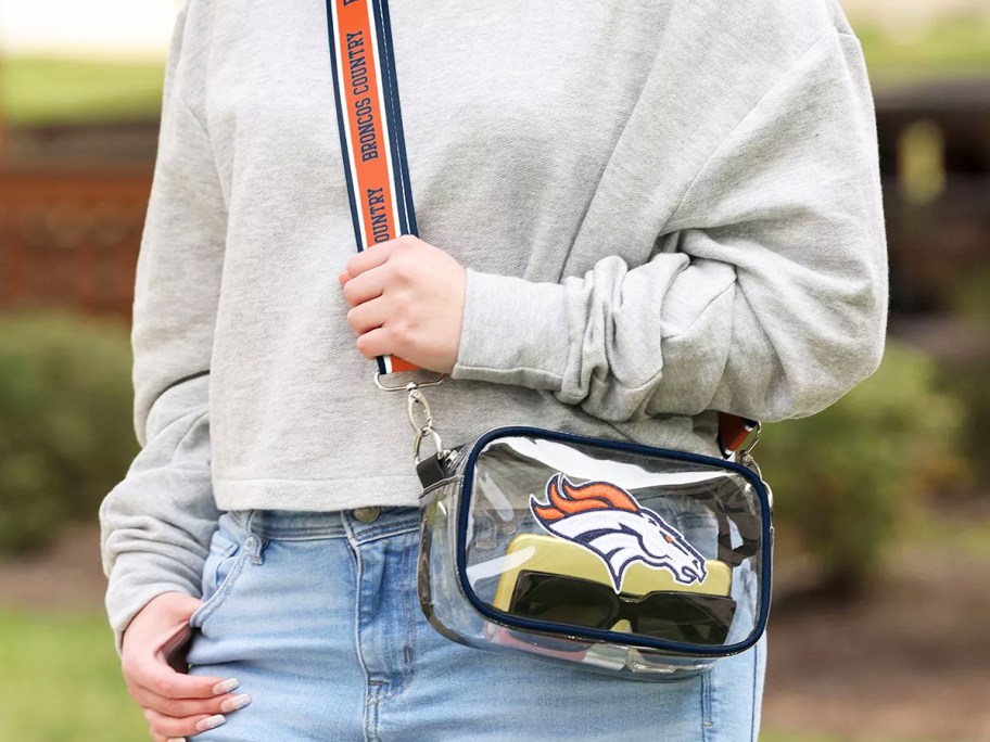 woman with a denver broncos crossbody bag