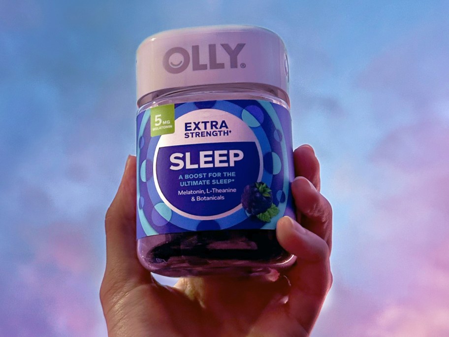 hand holding up a bottle of OLLY Extra Strength Sleep Gummies