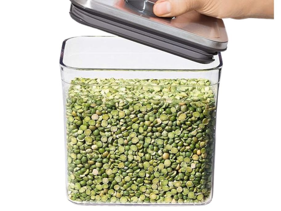 hand lifting lid on OXO Steel POP Container Big Medium Square 4.4-Quart with lentils in it