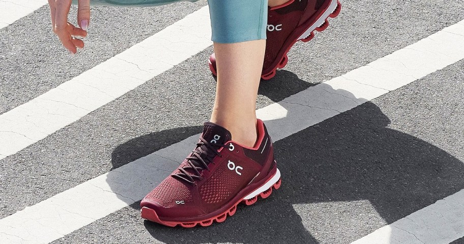 woman wearing maroon on cloud running shoes