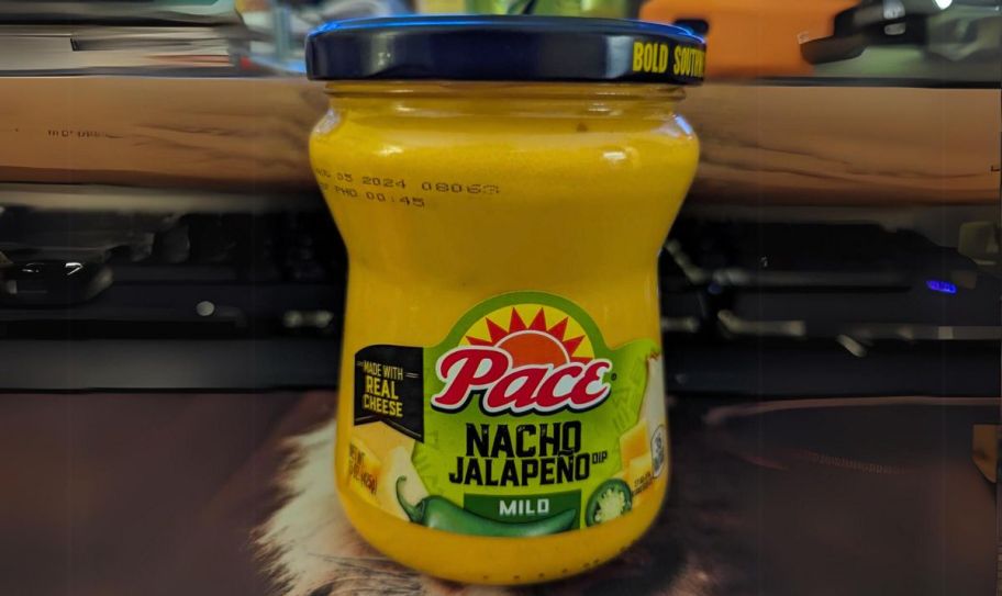 a jar of pace queso on a work desk