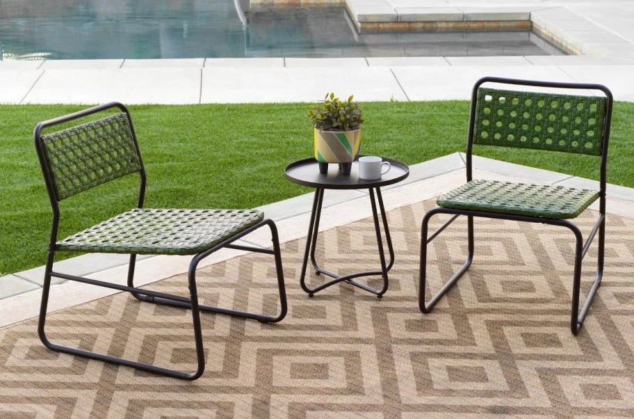 Patio Bistro set outside on a rug.