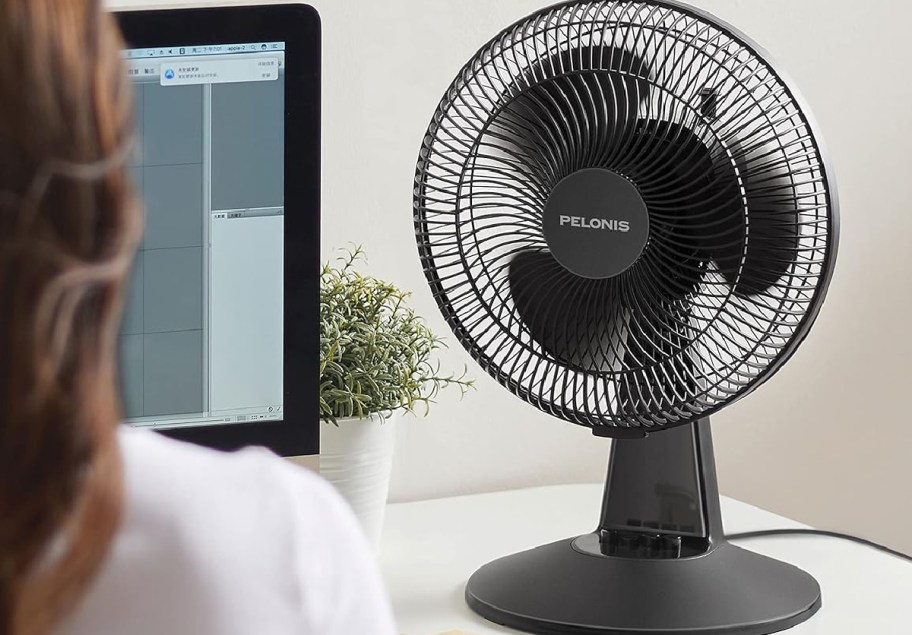 Pelonis table top fan in front of womans face
