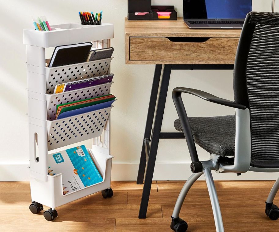 Pen+Gear 5-Tier Moveable Organization & Storage Cart filled with supplies standing next to desk and chair