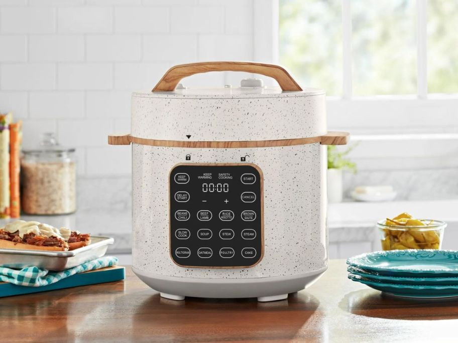 Pioneer Woman Instant Pot in Linen Speckle on a counter int eh kitchen 