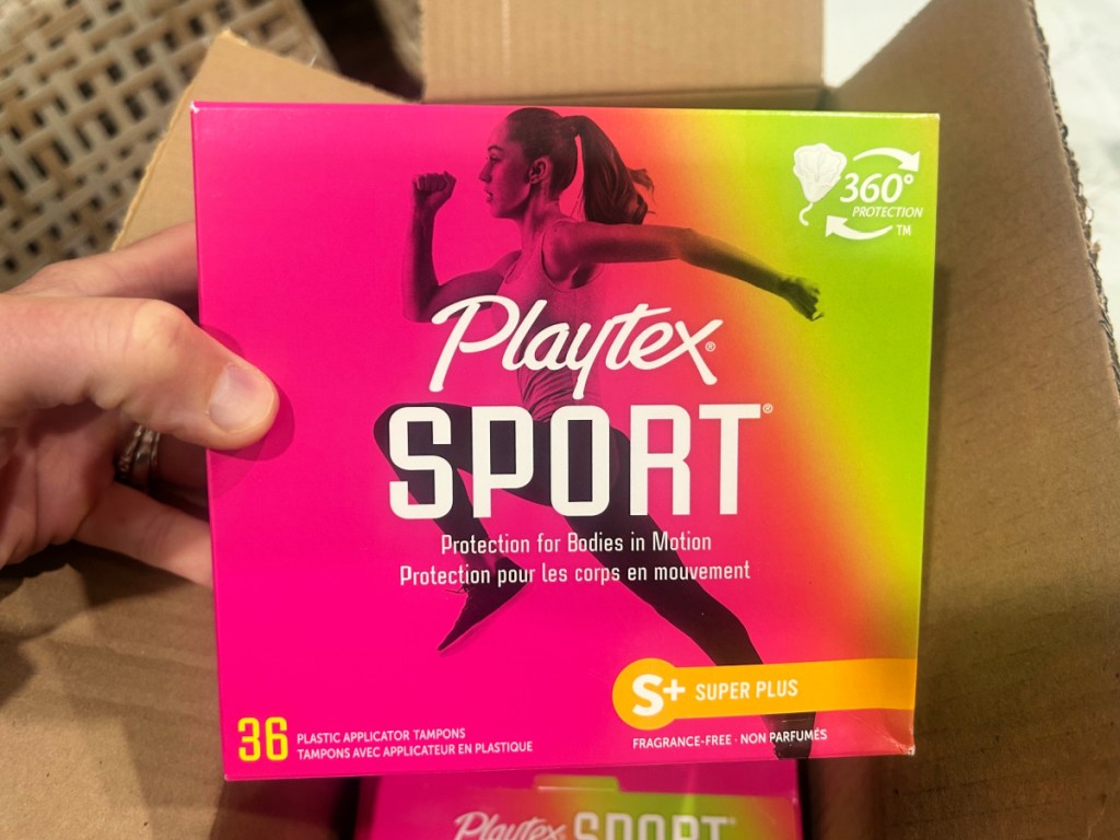 person holding up box of Playtex sport Tampon box