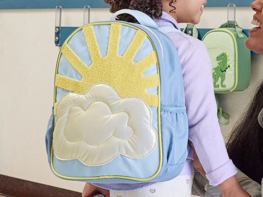 Little girl wearing a Little Critters Iridescent Cloud Backpack