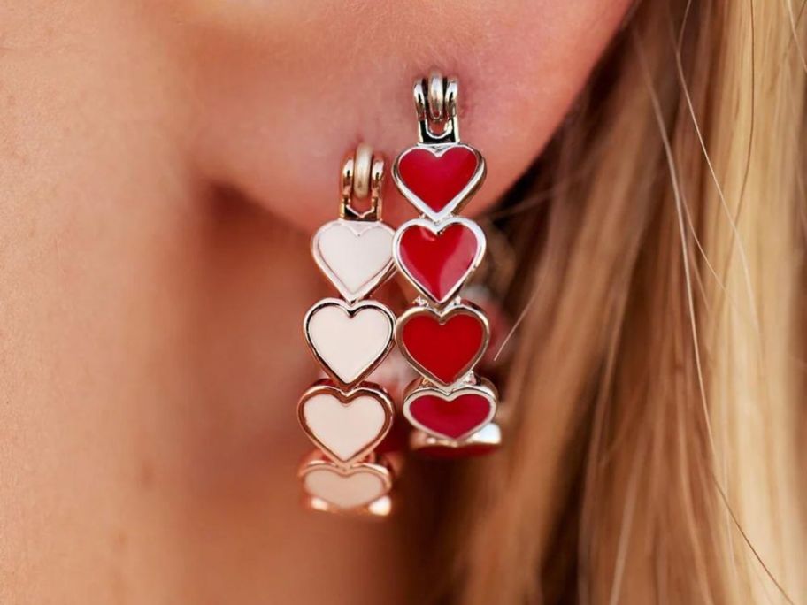 Pura Vida Love Hearts Hoop Earrings in a woman's ear