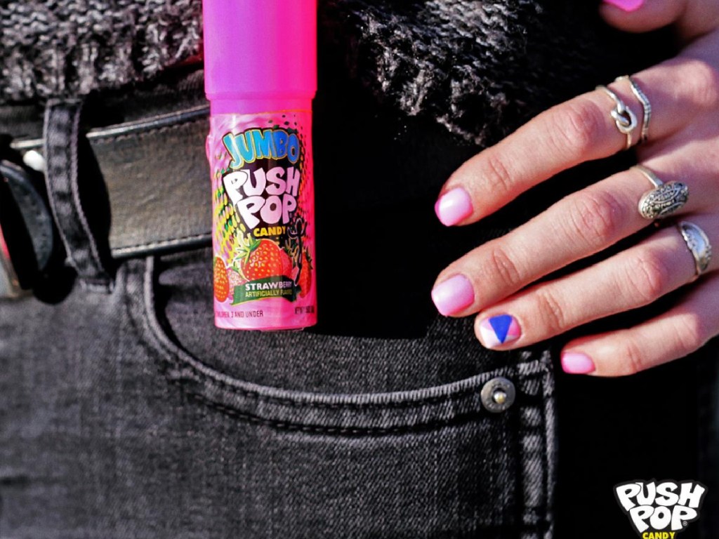 pink push pop candy clipped to black pants