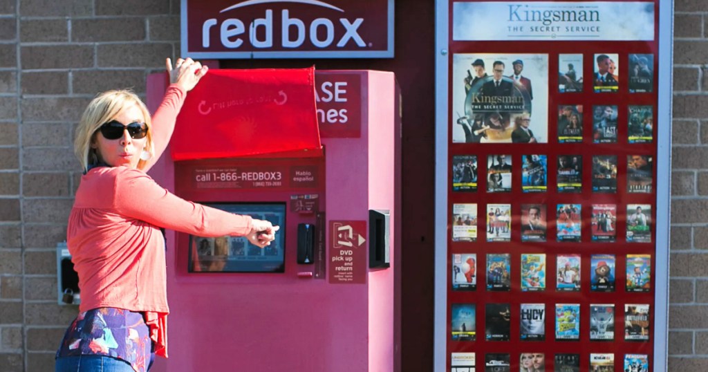 woman standing in front of redbox machine