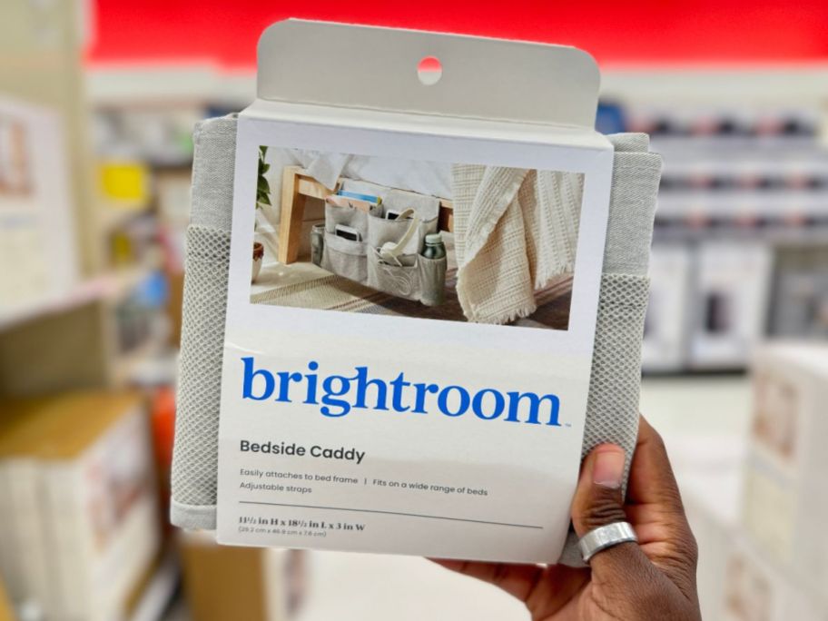 Room Essentials Bedside Caddy package being held by hand in store