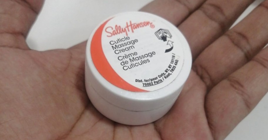 hand holding a small container of Sally Hansen Cuticle Massage Cream