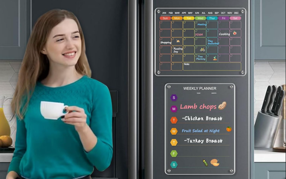 woman holding coffee cup leaning against fridge with monthly and weekly calendar on fridge door