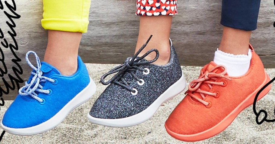 kids feet with blue, grey, and red sneakers